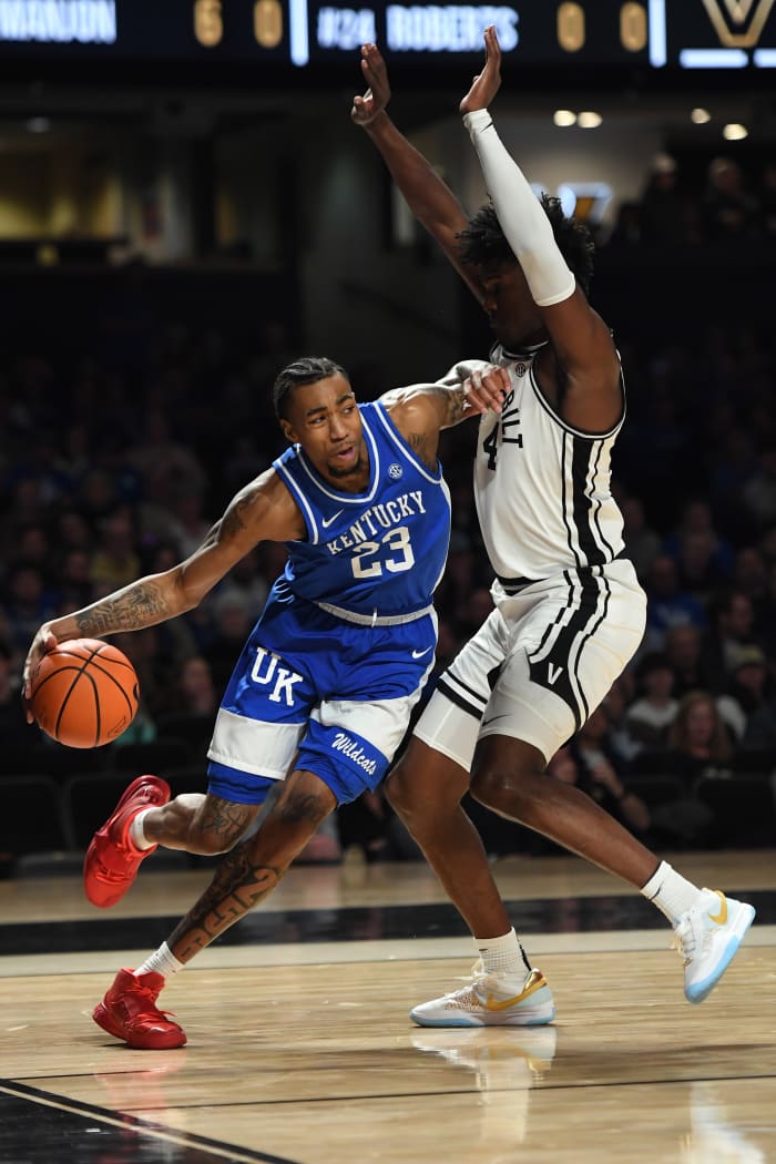 Feb 6, 2024; Nashville, Tennessee, USA; Kentucky Wildcats guard Jordan Burks (23) handles the ball against Vanderbilt Commodores forward JaQualon Roberts (24) during the first half at Memorial Gymnasium. Mandatory Credit: Christopher Hanewinckel-USA TODAY Sports